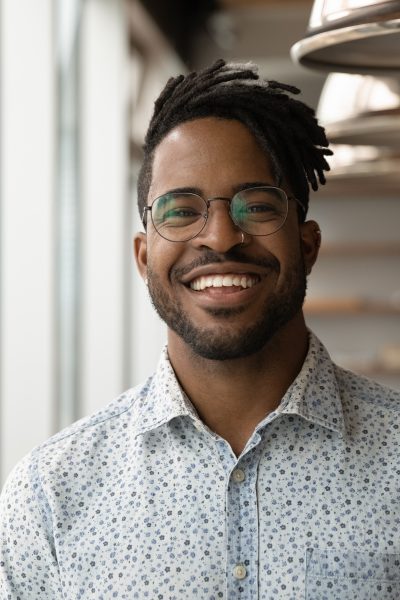 Headshot Portrait Of Smiling Biracial Man Posing